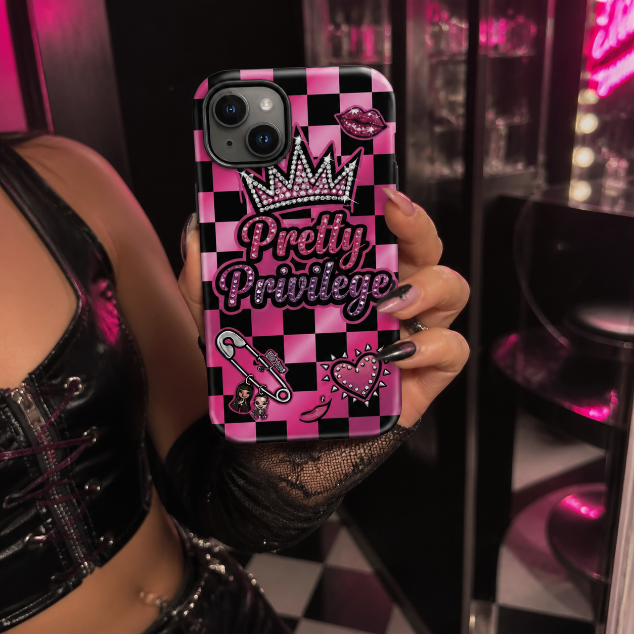 Pretty Privilege Brat tough phone case held in a pink and black dressing room